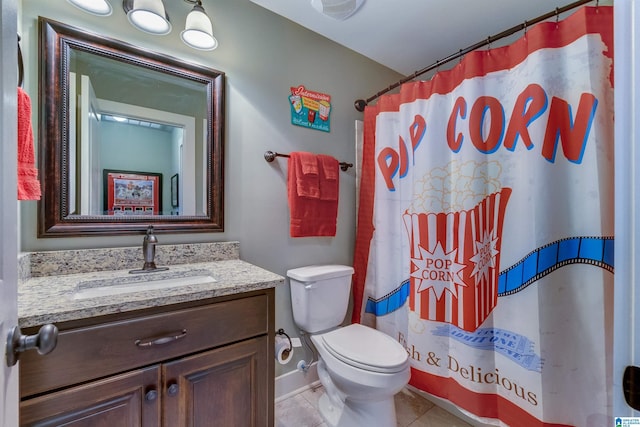 bathroom with vanity, curtained shower, tile patterned floors, and toilet