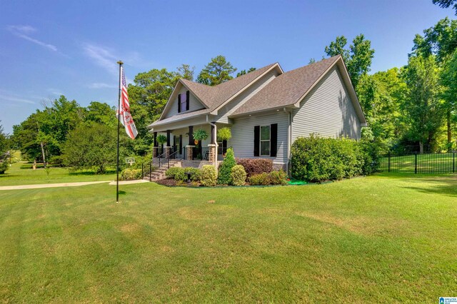 view of front of property featuring covered porch and a front lawn