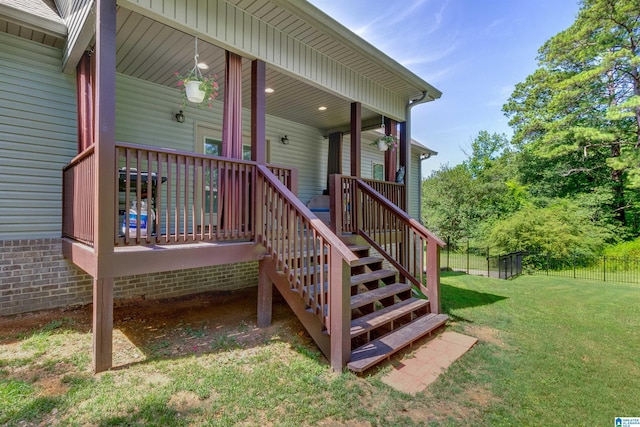 property entrance featuring a wooden deck and a yard