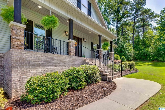 view of home's exterior featuring a yard and a porch