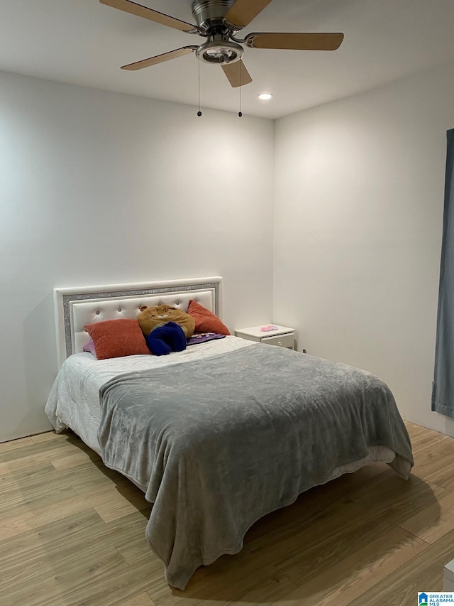 bedroom with light hardwood / wood-style floors and ceiling fan