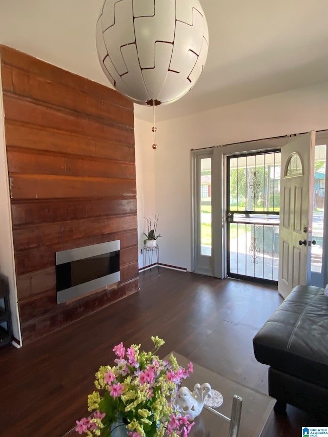 unfurnished living room featuring wooden walls and hardwood / wood-style floors