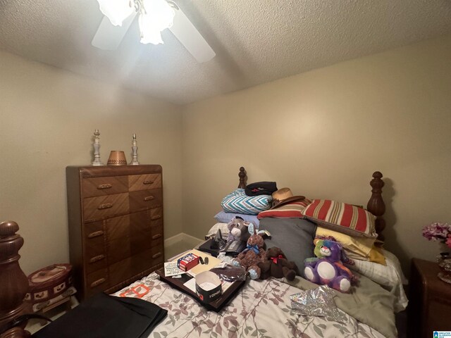 bedroom featuring ceiling fan and a textured ceiling