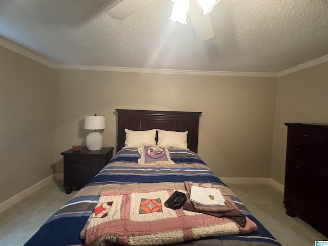 carpeted bedroom with ceiling fan, a textured ceiling, and ornamental molding