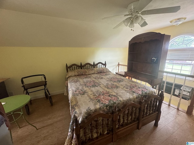 bedroom with wood-type flooring, vaulted ceiling, and ceiling fan