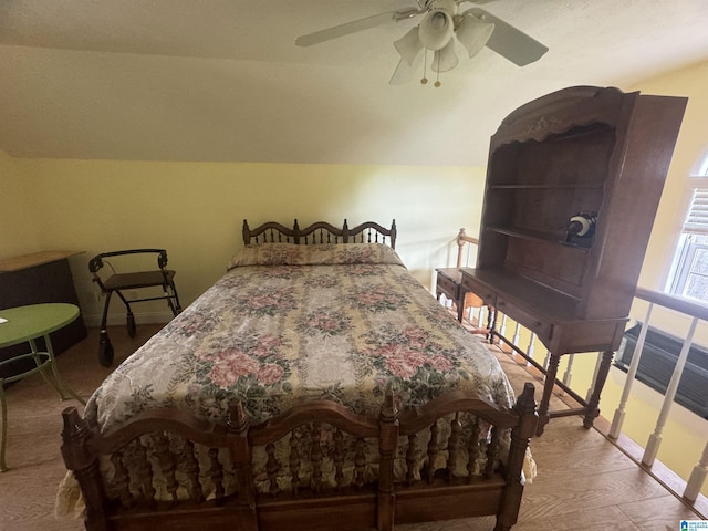 bedroom featuring ceiling fan, vaulted ceiling, and hardwood / wood-style flooring