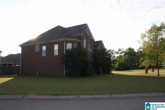 view of side of home featuring a lawn