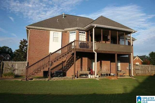 rear view of house with a lawn