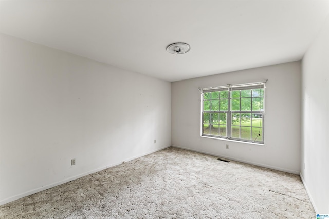 unfurnished room featuring light colored carpet