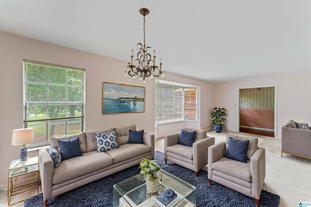 living room with a chandelier and carpet flooring