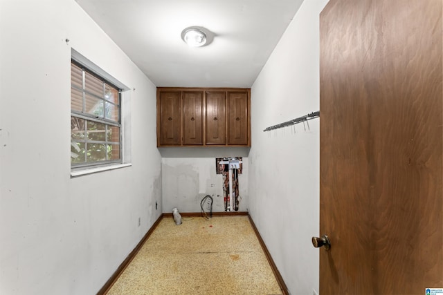 laundry area with cabinets