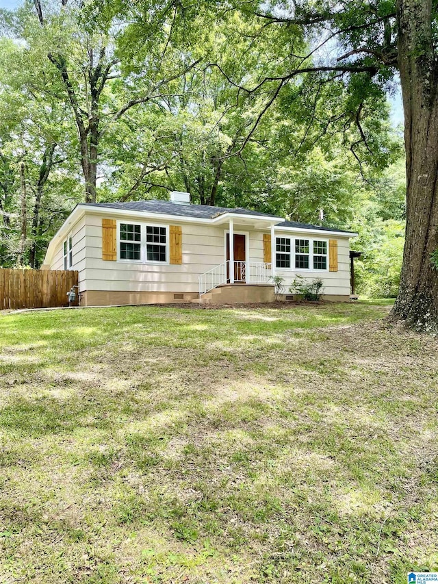 single story home with a front yard, crawl space, and fence