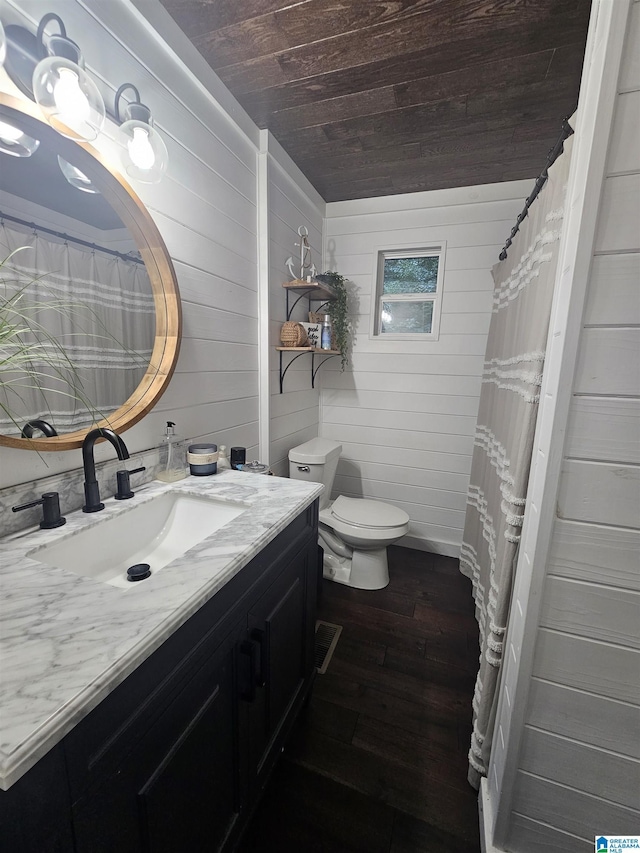 bathroom with wood-type flooring, vanity, walk in shower, toilet, and wooden ceiling