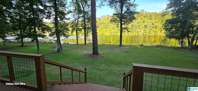 view of yard with a deck with water view