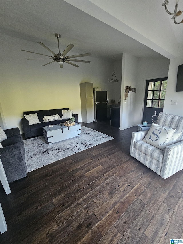 living room featuring ceiling fan, lofted ceiling, and dark hardwood / wood-style flooring