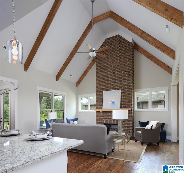 living room featuring beamed ceiling, dark hardwood / wood-style floors, a brick fireplace, and high vaulted ceiling