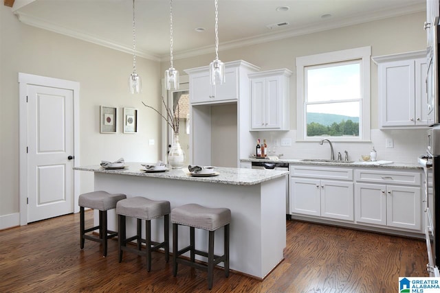 kitchen with sink, a kitchen island, and dark wood-type flooring