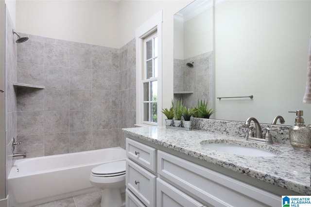 full bathroom featuring vanity, tiled shower / bath, tile patterned flooring, and toilet