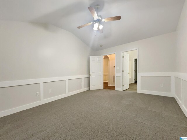 unfurnished room featuring ceiling fan, a tray ceiling, and wood-type flooring