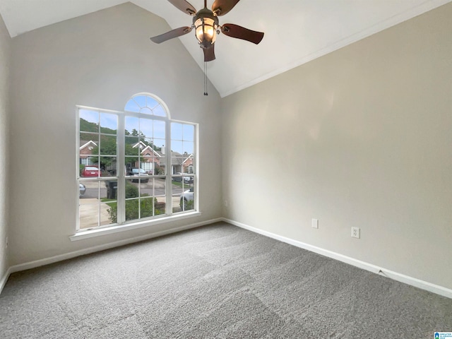 carpeted spare room with ceiling fan and high vaulted ceiling