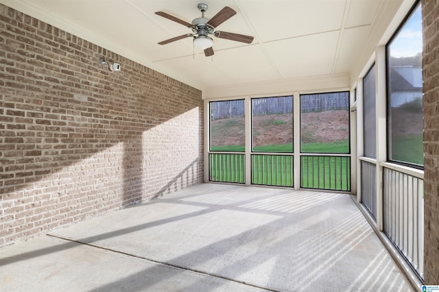 unfurnished sunroom with ceiling fan