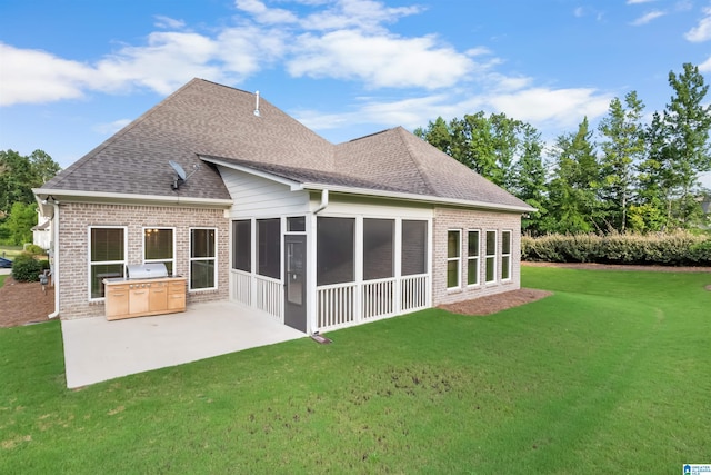 back of property featuring a sunroom, a patio area, and a lawn