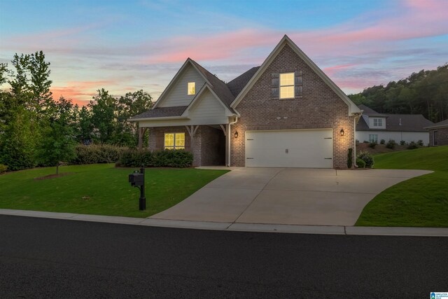 view of front facade featuring a garage and a lawn