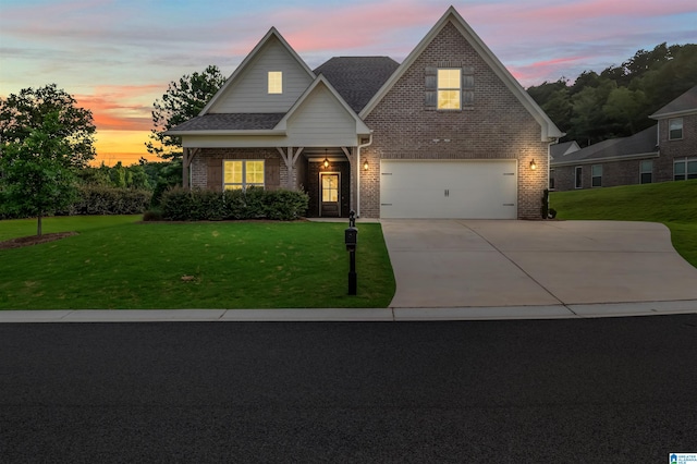 view of front facade featuring a garage and a yard