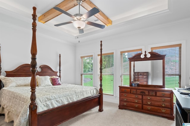 carpeted bedroom with beamed ceiling, ornamental molding, and ceiling fan