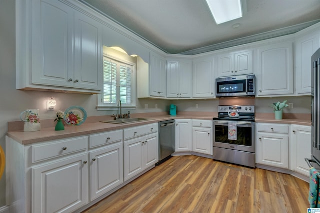 kitchen featuring white cabinetry, appliances with stainless steel finishes, sink, and light hardwood / wood-style floors