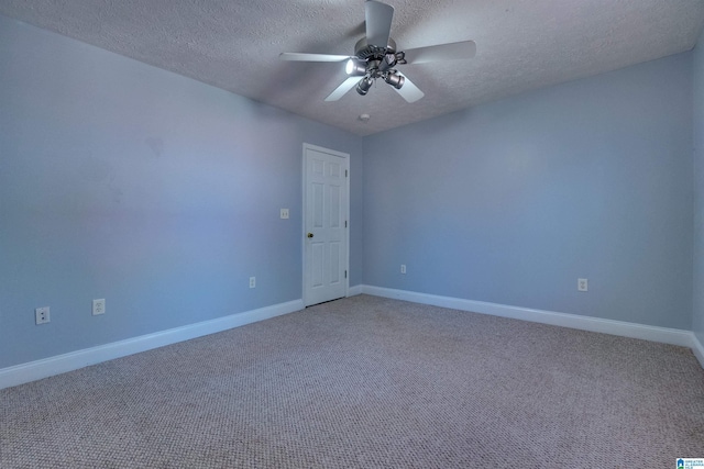 carpeted empty room with ceiling fan and a textured ceiling