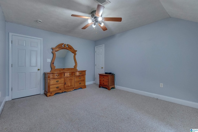 carpeted bedroom featuring ceiling fan, lofted ceiling, and a textured ceiling