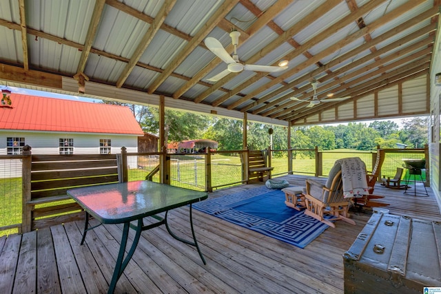 deck featuring ceiling fan and a lawn