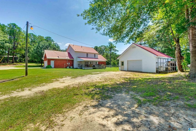 view of yard with a garage and an outdoor structure