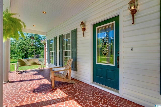 view of exterior entry featuring a porch