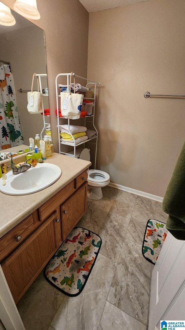 bathroom featuring toilet and vanity