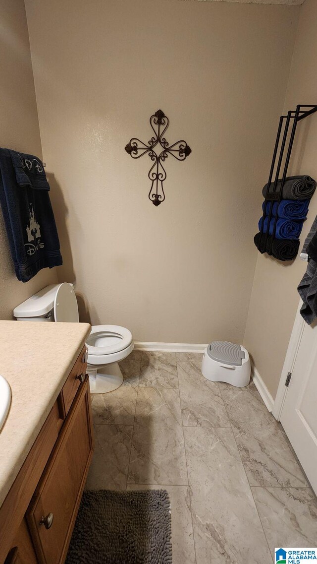 bathroom with toilet and vanity