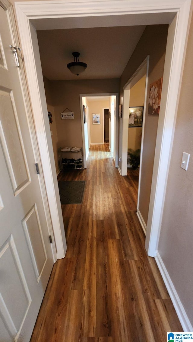 corridor featuring dark wood-type flooring