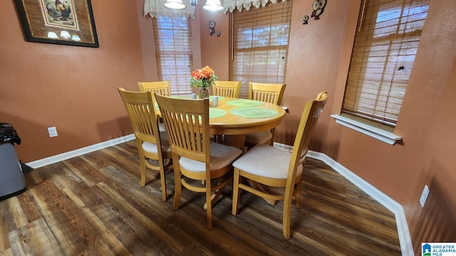 dining room with dark hardwood / wood-style flooring and a healthy amount of sunlight