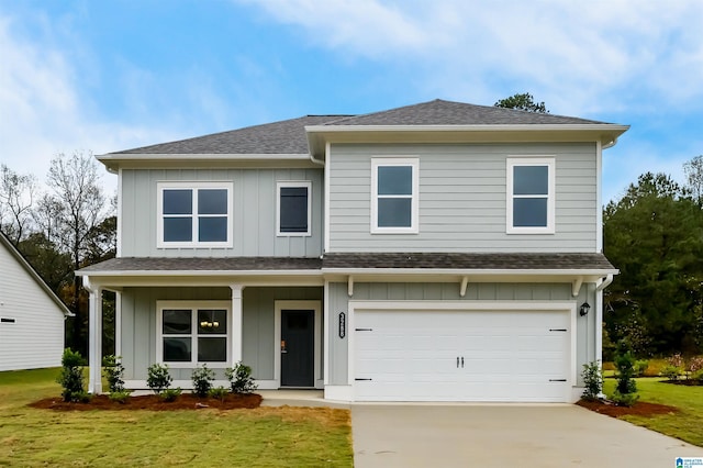 view of front of home with a garage and a front lawn