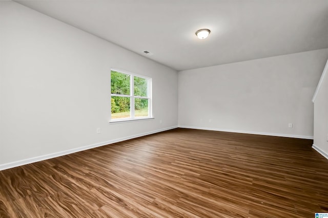 spare room featuring dark wood-type flooring