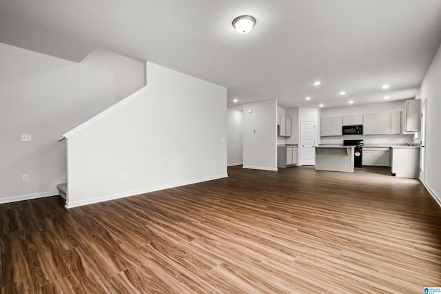 unfurnished living room featuring dark hardwood / wood-style flooring