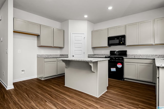 kitchen featuring a center island, dark hardwood / wood-style floors, gray cabinets, and black appliances