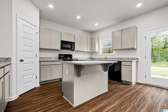 kitchen with gray cabinetry, a center island, dark wood-type flooring, and black appliances