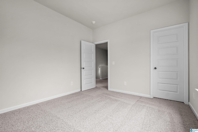 spare room featuring light colored carpet