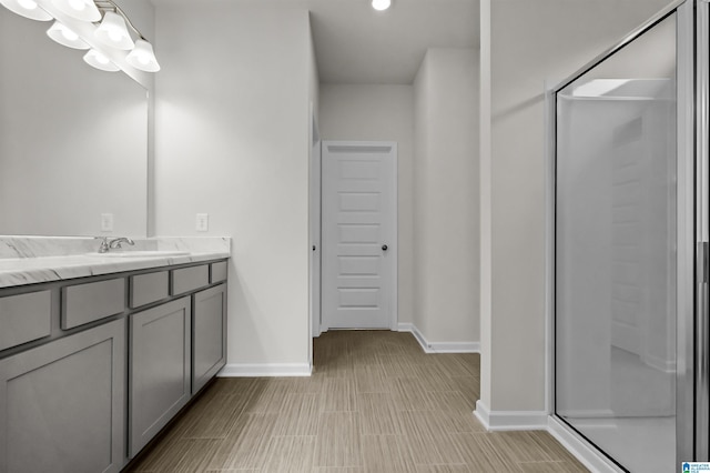 bathroom featuring vanity and a shower with shower door