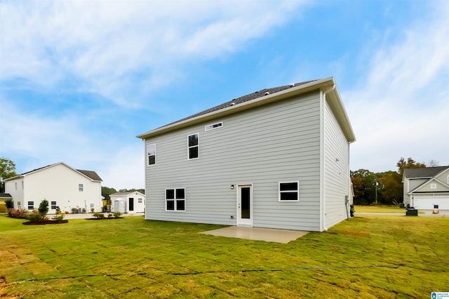 back of property with a yard and a patio