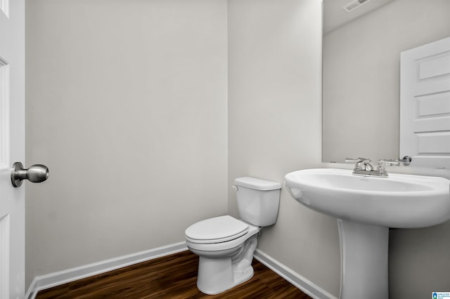 bathroom featuring sink, hardwood / wood-style floors, and toilet