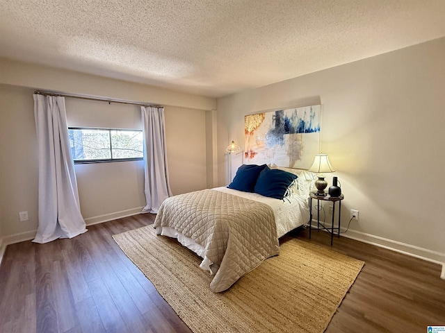 bedroom featuring a textured ceiling and dark hardwood / wood-style floors