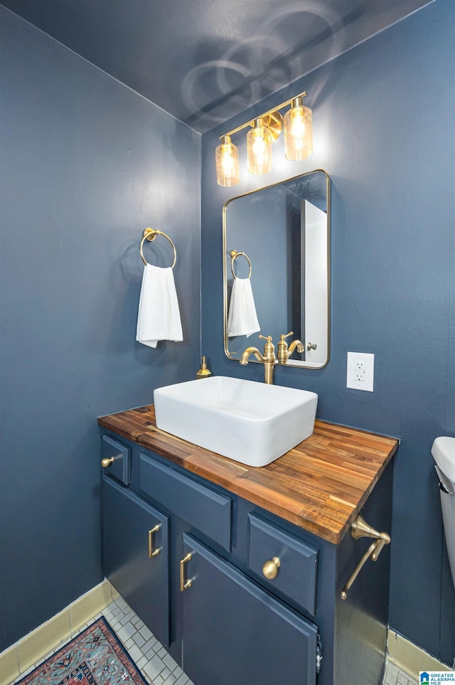 bathroom with tile patterned floors, vanity, and toilet